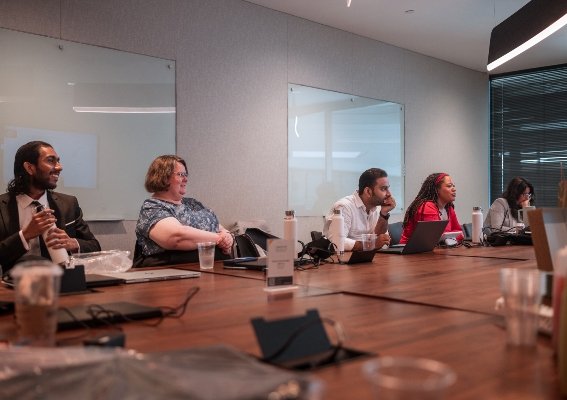 Professionals collaborating around a conference table during a team meeting.